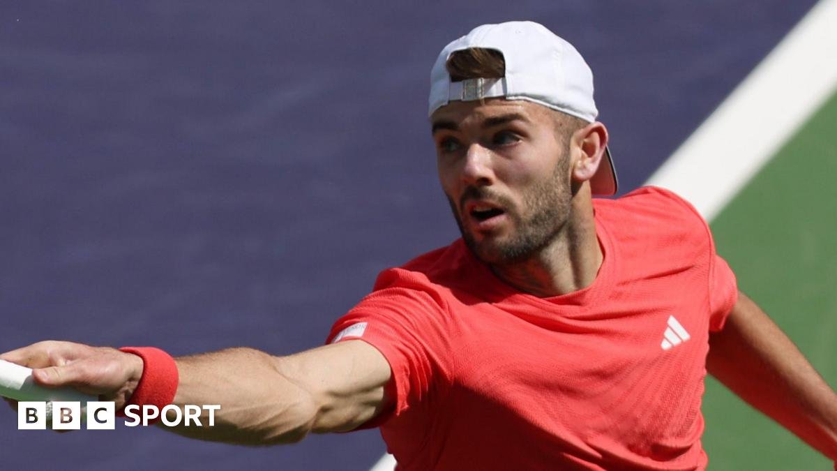 Jacob Fearnley stretches for a forehand return against Joao Fonseca in Indian Wells