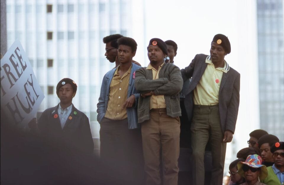 a group of men in black berets stand together