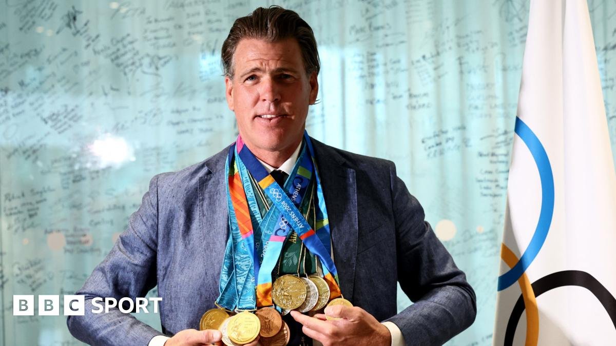 Former USA swimmer Gary Hall Jr wears all 10 of his replica Olympic medals given to him by the International Olympic Committee